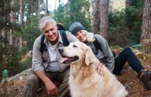Senior couple out hiking with their dog
